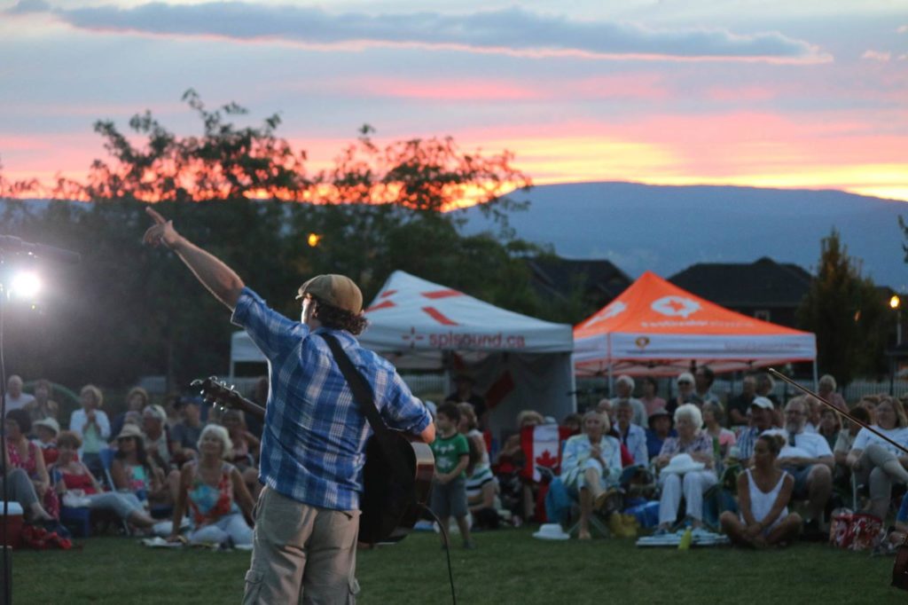 Musician performing at sunset in Kelowna for Parks Alive!